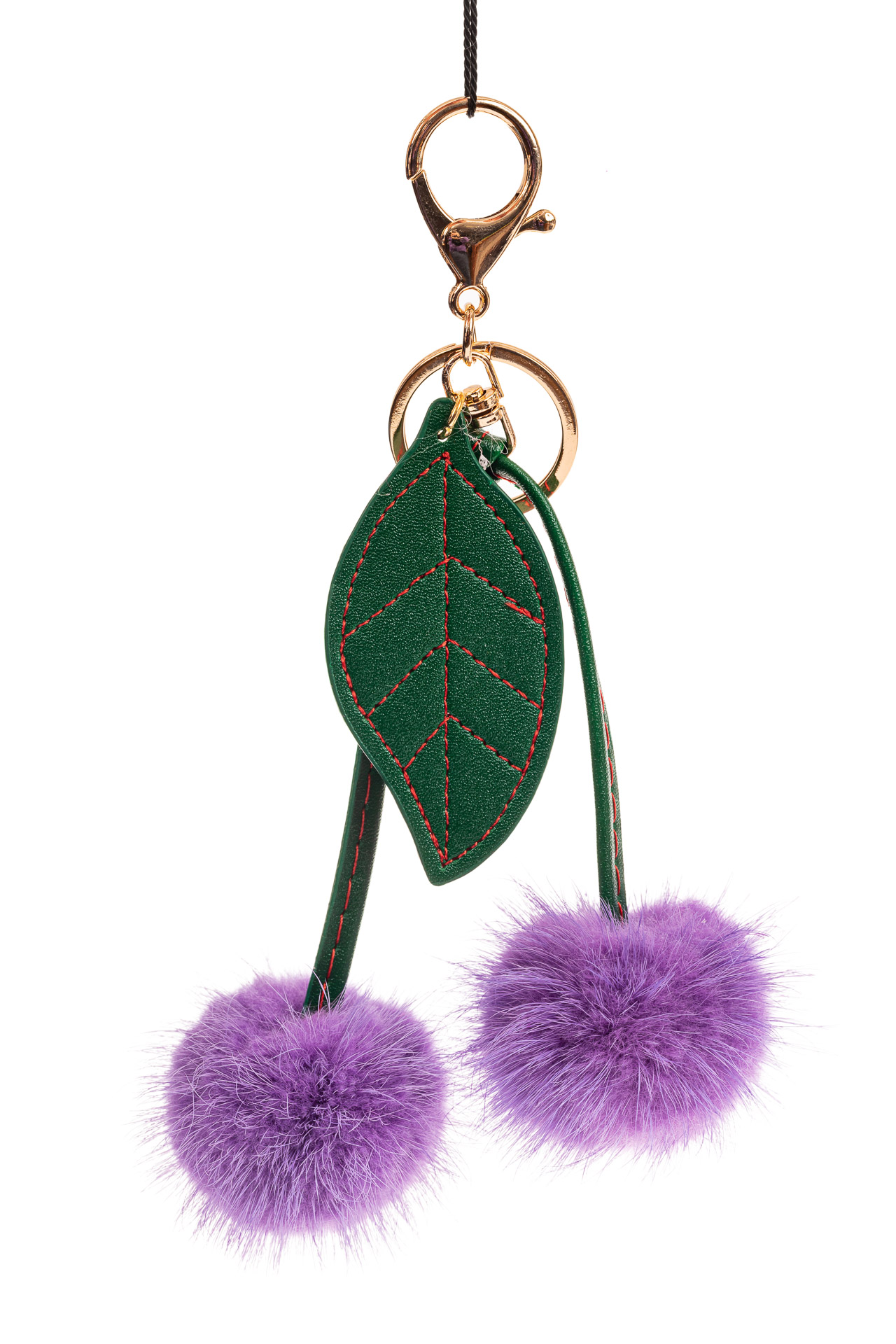 На фото 1 - Сувенирный брелок из натурального меха фиолетового цвета
